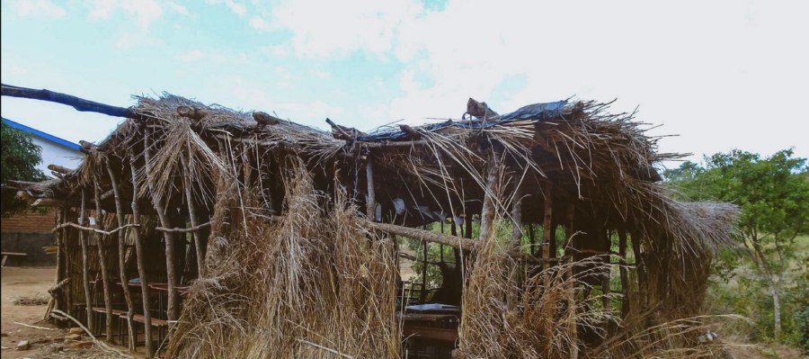an old dilapidated school building made of grass and sticks without walls in Malawi
