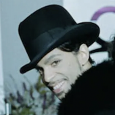 Photo of Prince wearing a hat and smiling